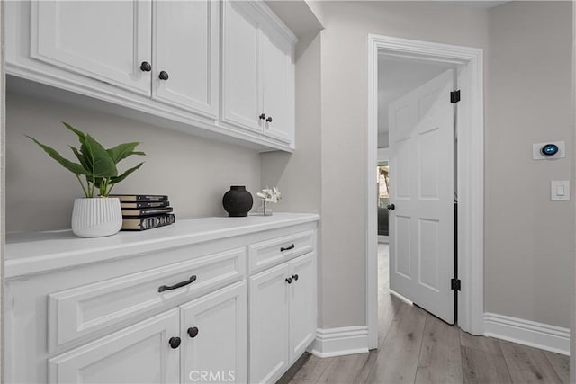 interior space featuring white cabinetry and light hardwood / wood-style flooring