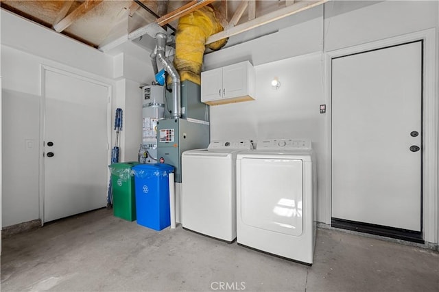 washroom with cabinets, separate washer and dryer, and strapped water heater