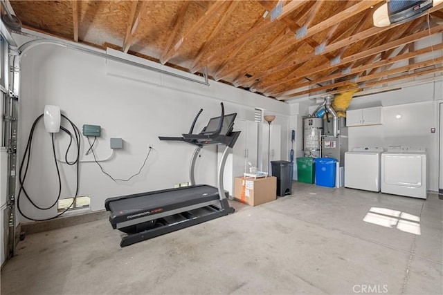 garage featuring secured water heater and washing machine and clothes dryer