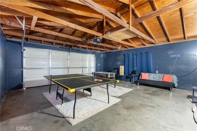 recreation room with concrete floors and lofted ceiling