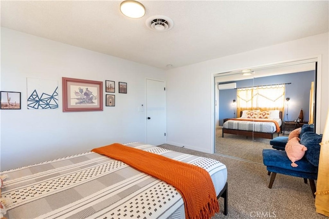 bedroom featuring a closet and a wall unit AC