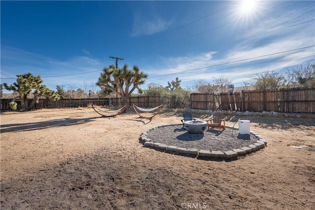 view of yard with a fire pit