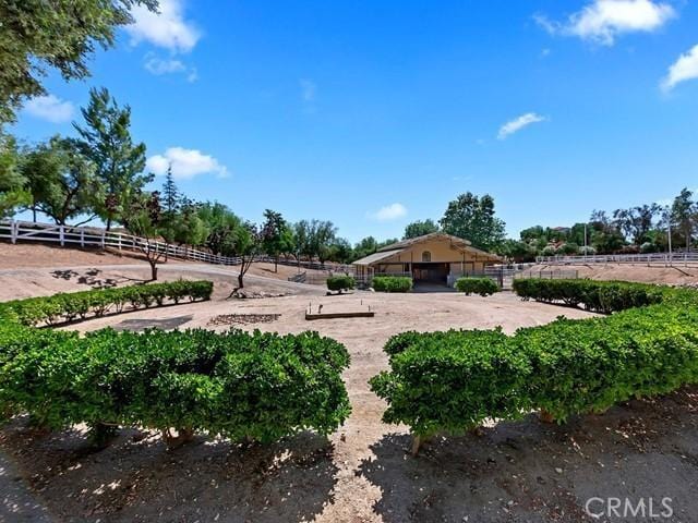 view of yard with a rural view and fence