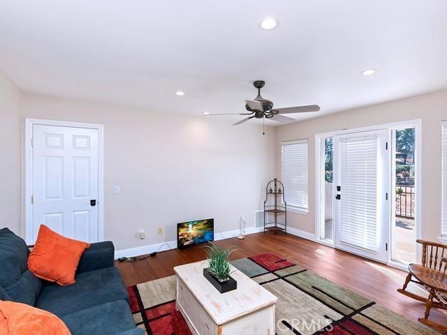 living room with recessed lighting, ceiling fan, baseboards, and wood finished floors