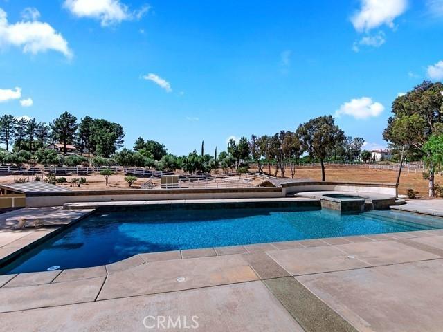 view of swimming pool with a pool with connected hot tub