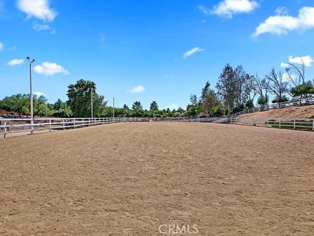 surrounding community featuring a rural view and an enclosed area