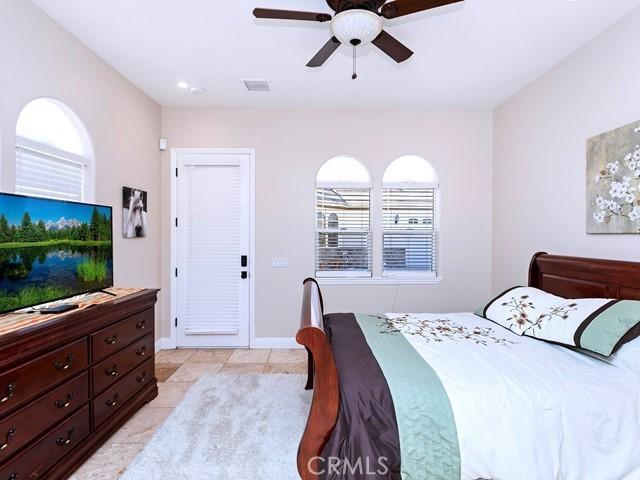 bedroom with light tile patterned floors, visible vents, ceiling fan, and baseboards