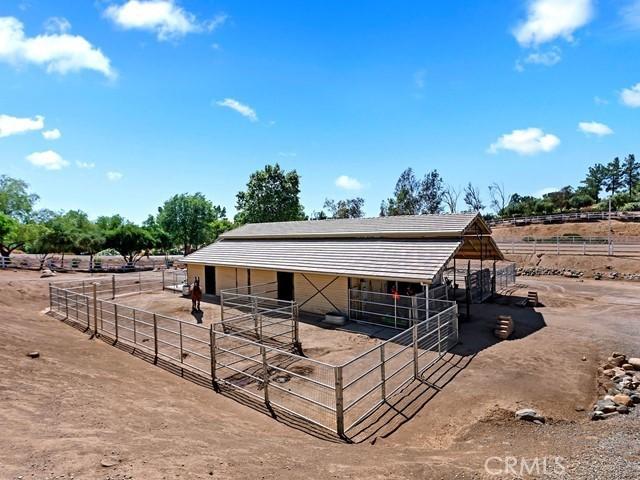 view of horse barn featuring a rural view