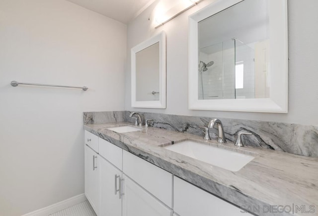 bathroom with tile patterned floors, tiled shower, and vanity