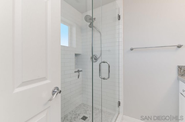 bathroom with walk in shower and vanity