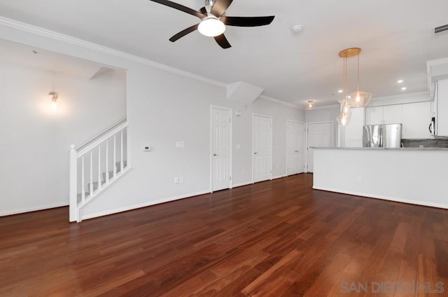 unfurnished living room with ceiling fan, dark hardwood / wood-style flooring, and ornamental molding