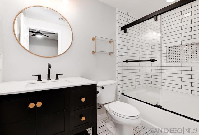 full bathroom featuring ceiling fan, bath / shower combo with glass door, toilet, and vanity