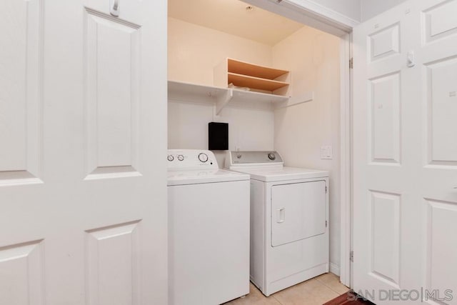 washroom with washer and dryer and light tile patterned flooring