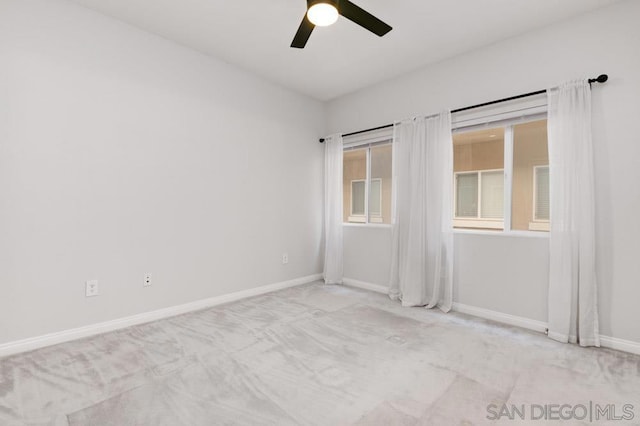 empty room with ceiling fan and light colored carpet