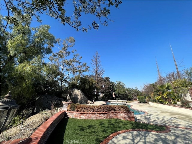 6966 Ranch View Rd, Riverside, CA 92506 - view of grassy yard featuring an outdoor pool and a patio area