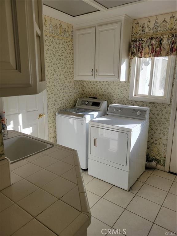 6966 Ranch View Rd, Riverside, CA 92506 - washroom with cabinet space, washer and clothes dryer, light tile patterned flooring, and wallpapered walls