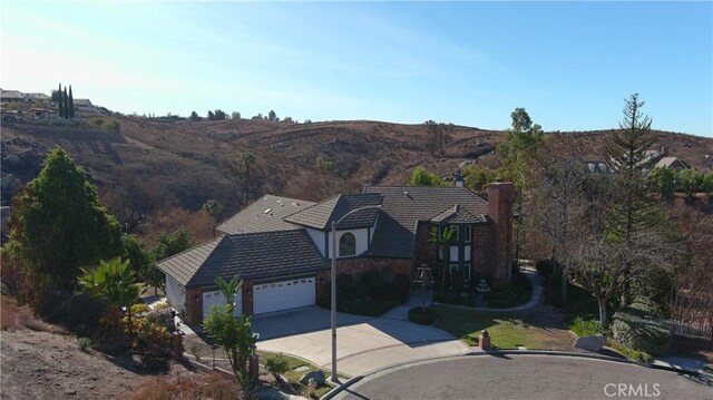 6966 Ranch View Rd, Riverside, CA 92506 - view of front of home with concrete driveway, a garage, and a tiled roof