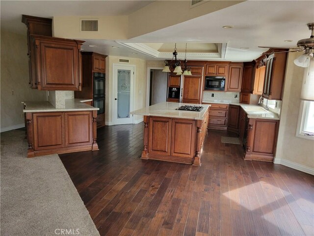 6966 Ranch View Rd, Riverside, CA 92506 - kitchen featuring black appliances, a tray ceiling, dark wood finished floors, brown cabinets, and crown molding