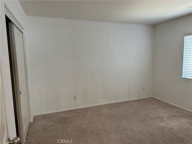 empty room featuring light colored carpet