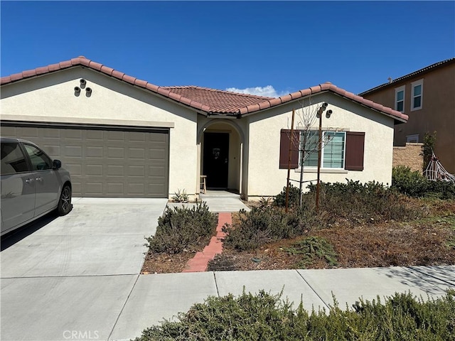 mediterranean / spanish-style home with a garage