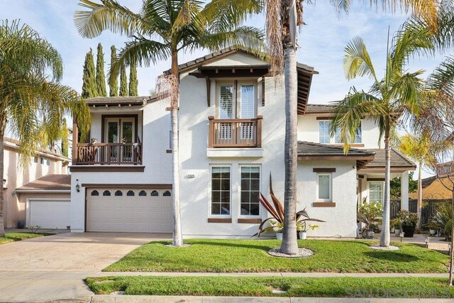 mediterranean / spanish home featuring a front yard, a garage, and a balcony