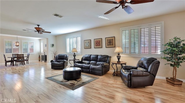 living room featuring ceiling fan and light hardwood / wood-style floors