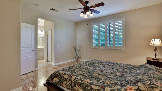 bedroom featuring ceiling fan, connected bathroom, and light wood-type flooring