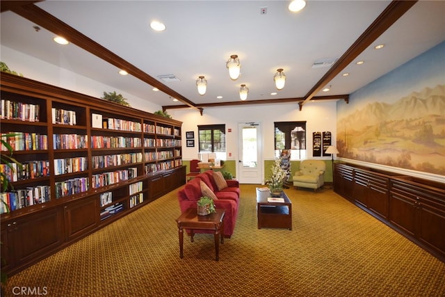 sitting room featuring beam ceiling, carpet, and crown molding