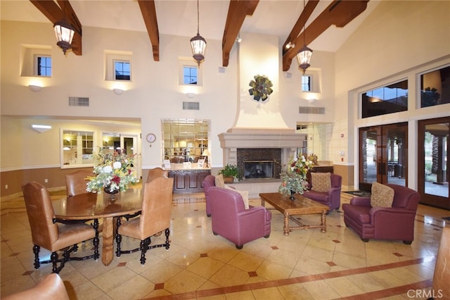 interior space featuring a high ceiling, french doors, and beamed ceiling