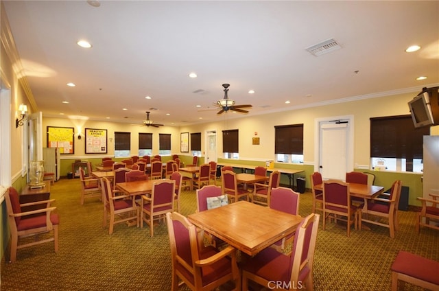 dining area with ceiling fan, ornamental molding, and carpet flooring