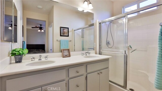 bathroom featuring walk in shower, vanity, and ceiling fan