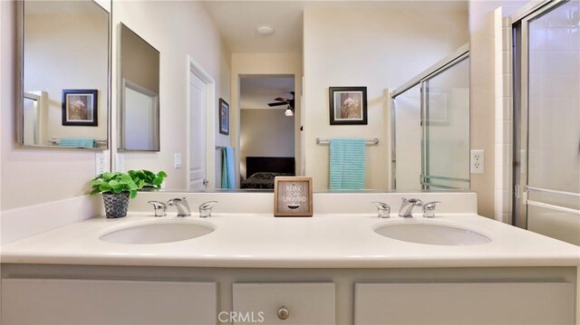 bathroom with vanity, ceiling fan, and an enclosed shower