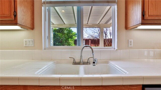 room details featuring sink and tile countertops