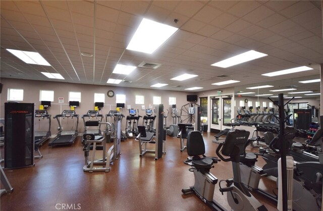 exercise room featuring a drop ceiling