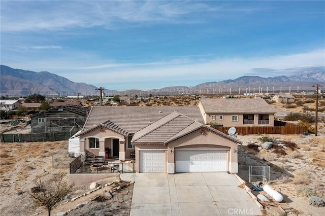 view of front of home with a mountain view and a garage