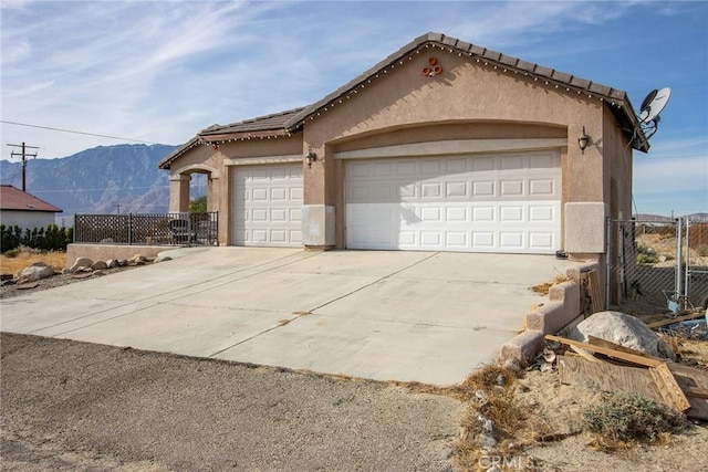 single story home with a garage and a mountain view