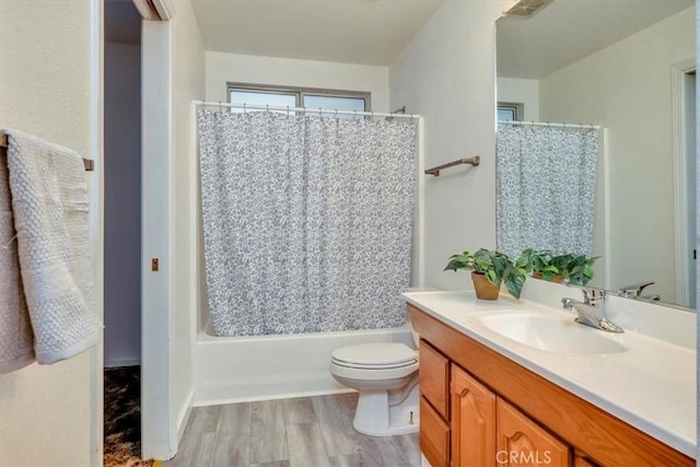 full bathroom with wood-type flooring, toilet, vanity, and shower / bathtub combination with curtain