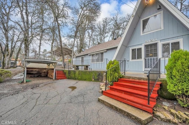 rear view of property with a carport