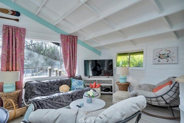 living room with hardwood / wood-style flooring, vaulted ceiling with beams, and wooden walls