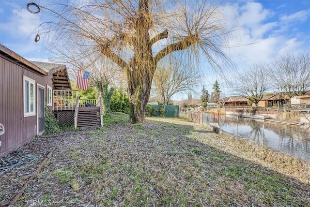 view of yard featuring a deck with water view