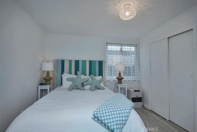 bedroom with a closet and light hardwood / wood-style flooring