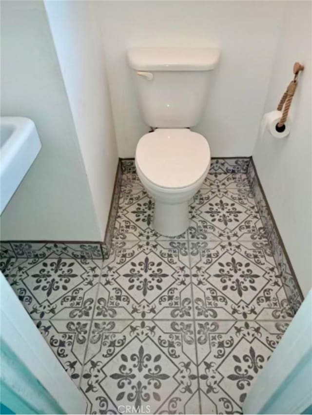 bathroom with tile patterned floors and toilet