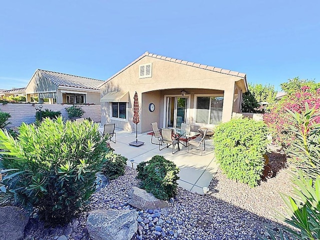 rear view of property featuring a patio area