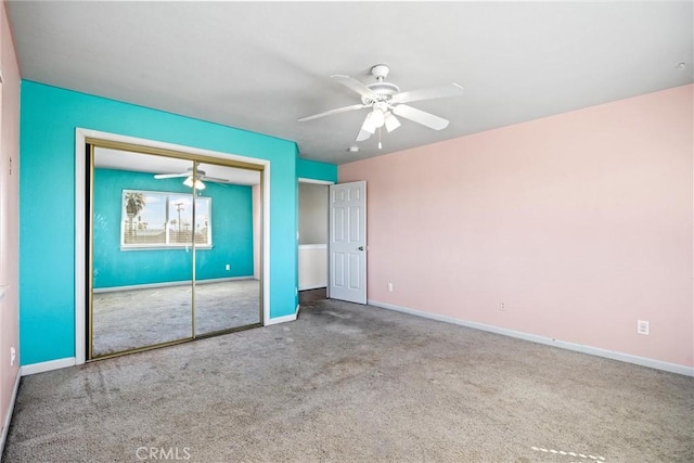 unfurnished bedroom with a closet, carpet, a ceiling fan, and baseboards