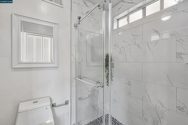 bathroom featuring toilet and walk in shower