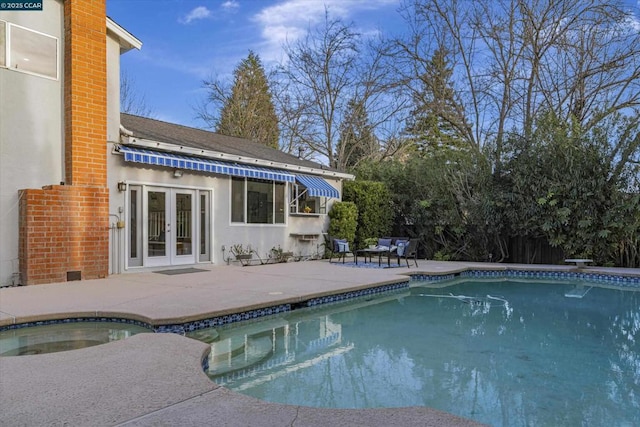 view of pool featuring french doors and a patio