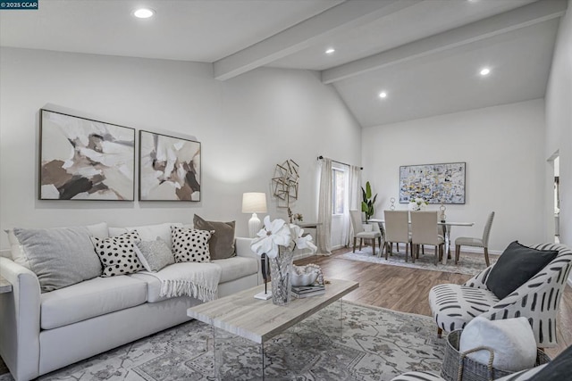 living room with lofted ceiling with beams and hardwood / wood-style flooring