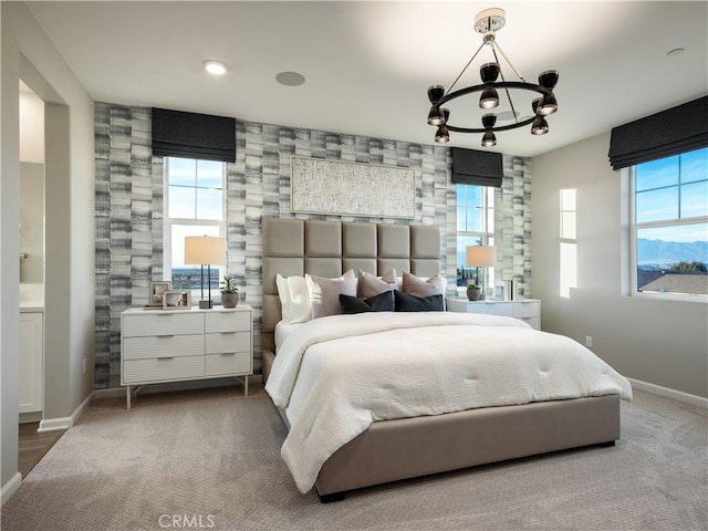 bedroom featuring carpet, a notable chandelier, and connected bathroom