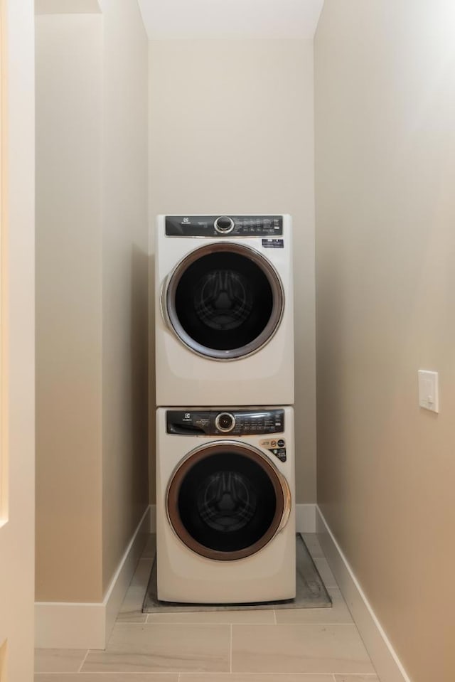 laundry area with stacked washer / dryer