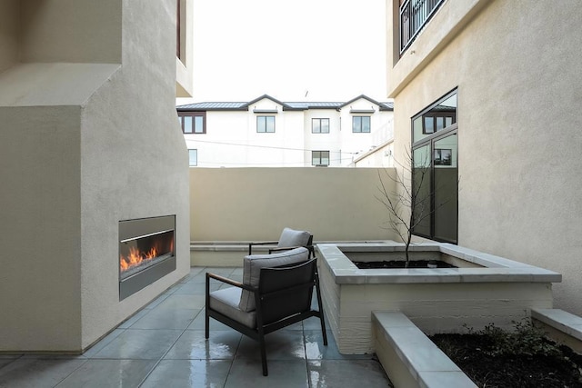 view of patio with an outdoor fireplace